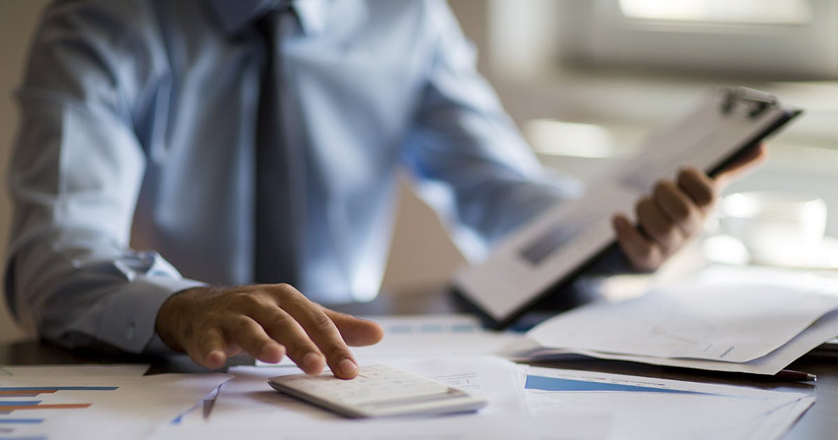 Business accounting concept, Business man using calculator with computer laptop, budget and loan paper in office.