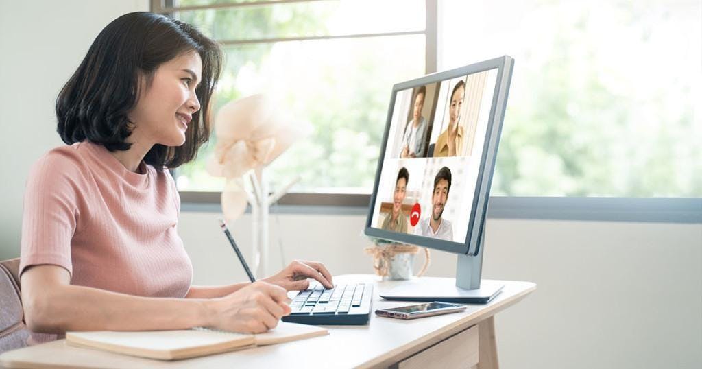Asian business woman talking to colleague team about plan in video conference. Group of multiethnic business people using computer for online meeting in video call conference. Smart working from home.